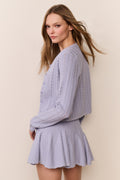 Light lavender pointelle cardigan, side view with long sleeves and button front