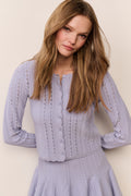 Light lavender pointelle knit cardigan with button placket and ruffled cuffs
