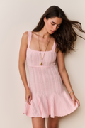 Pink pointelle mini dress with square neckline and flared hem, side angle