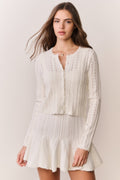 White pointelle stretch cardigan with open front and long sleeves, lightweight knit