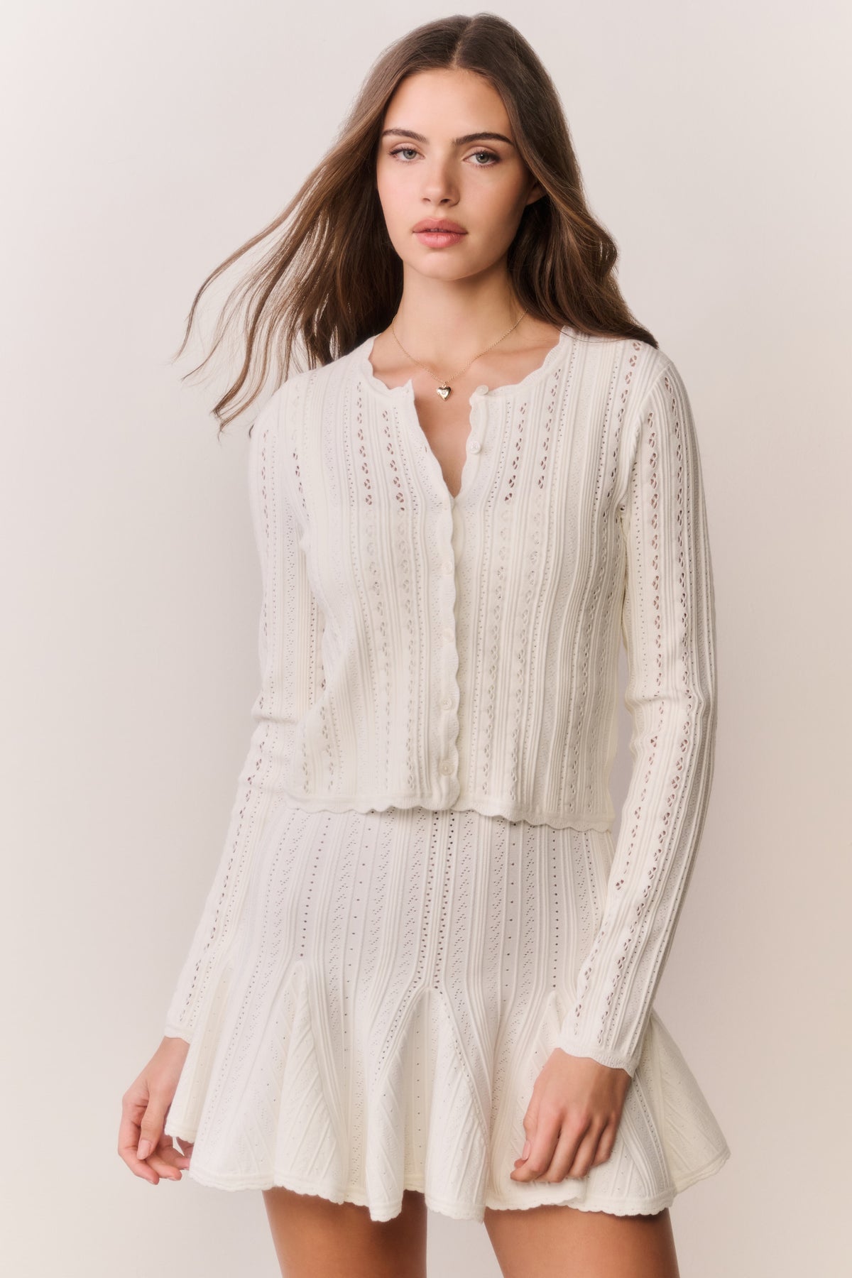 White pointelle stretch cardigan with open front and long sleeves, lightweight knit
