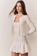White pointelle stretch cardigan with open front, long sleeves, scalloped trim