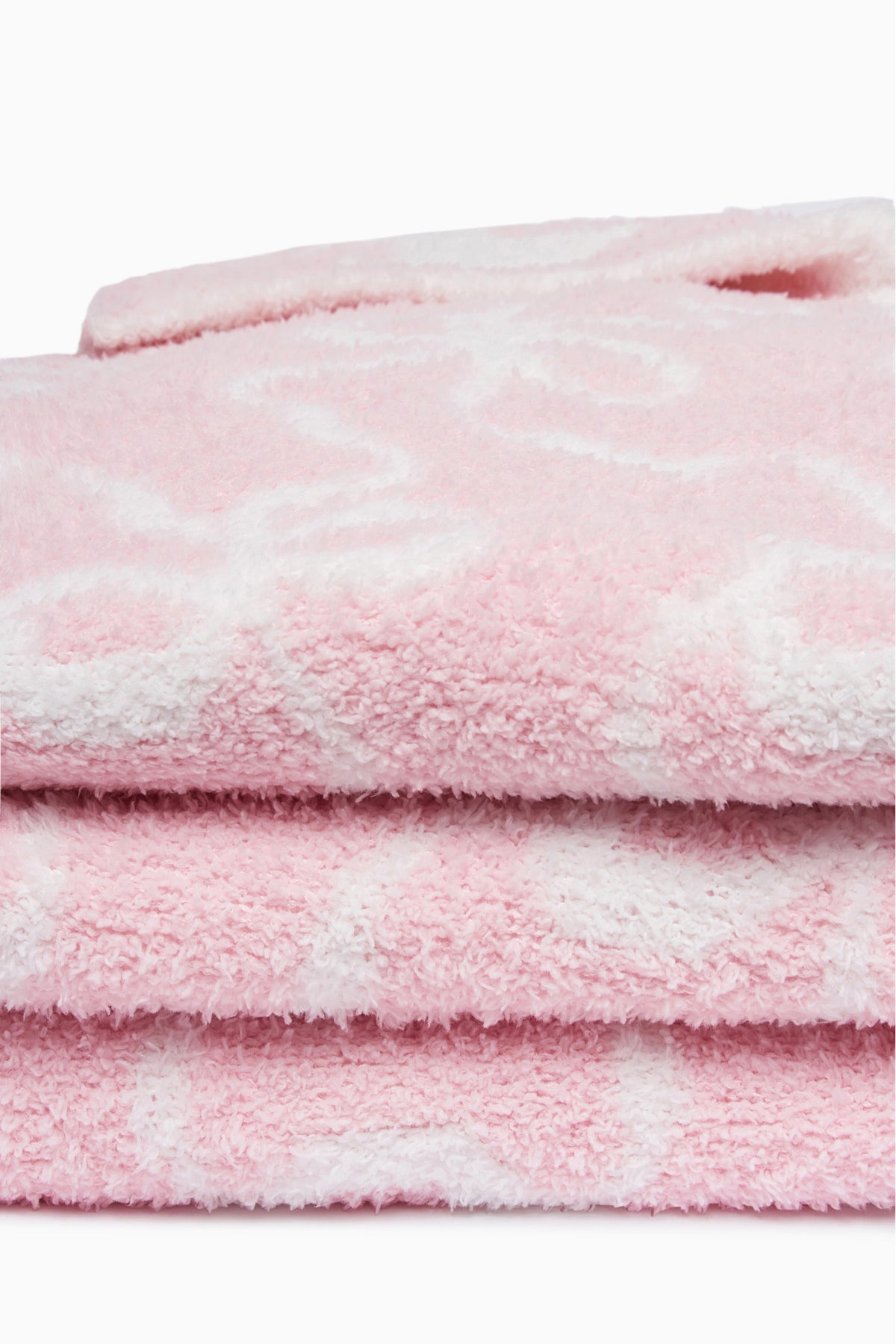 Pastel pink plush teddy bow blanket, close-up of layered fuzzy texture