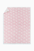 Pastel pink teddy bow blanket with allover white bow pattern and stitched edge