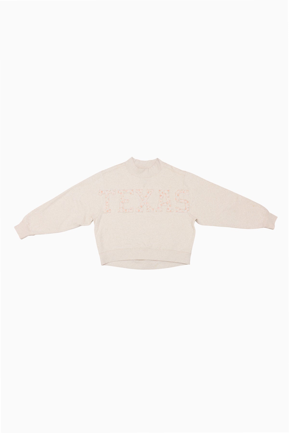 Cream mockneck crew sweatshirt with small pink dotted print at the center
