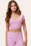 Light pink tween active top with rounded V neckline and short sleeves, small dotted print