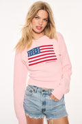 Blushing pink flag pullover sweater with blue-and-red striped emblem on chest