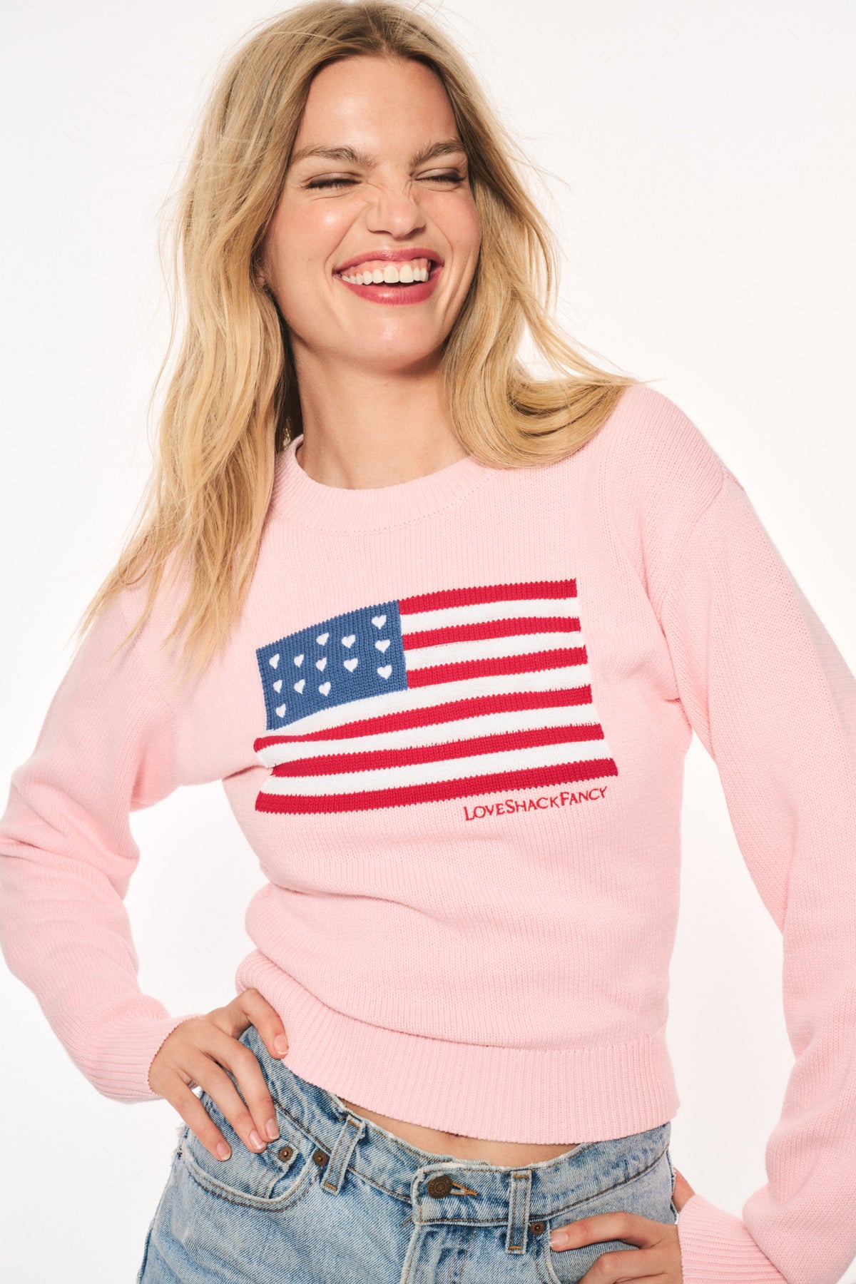 Blushing pink knit flag pullover with chest graphic and ribbed cuffs