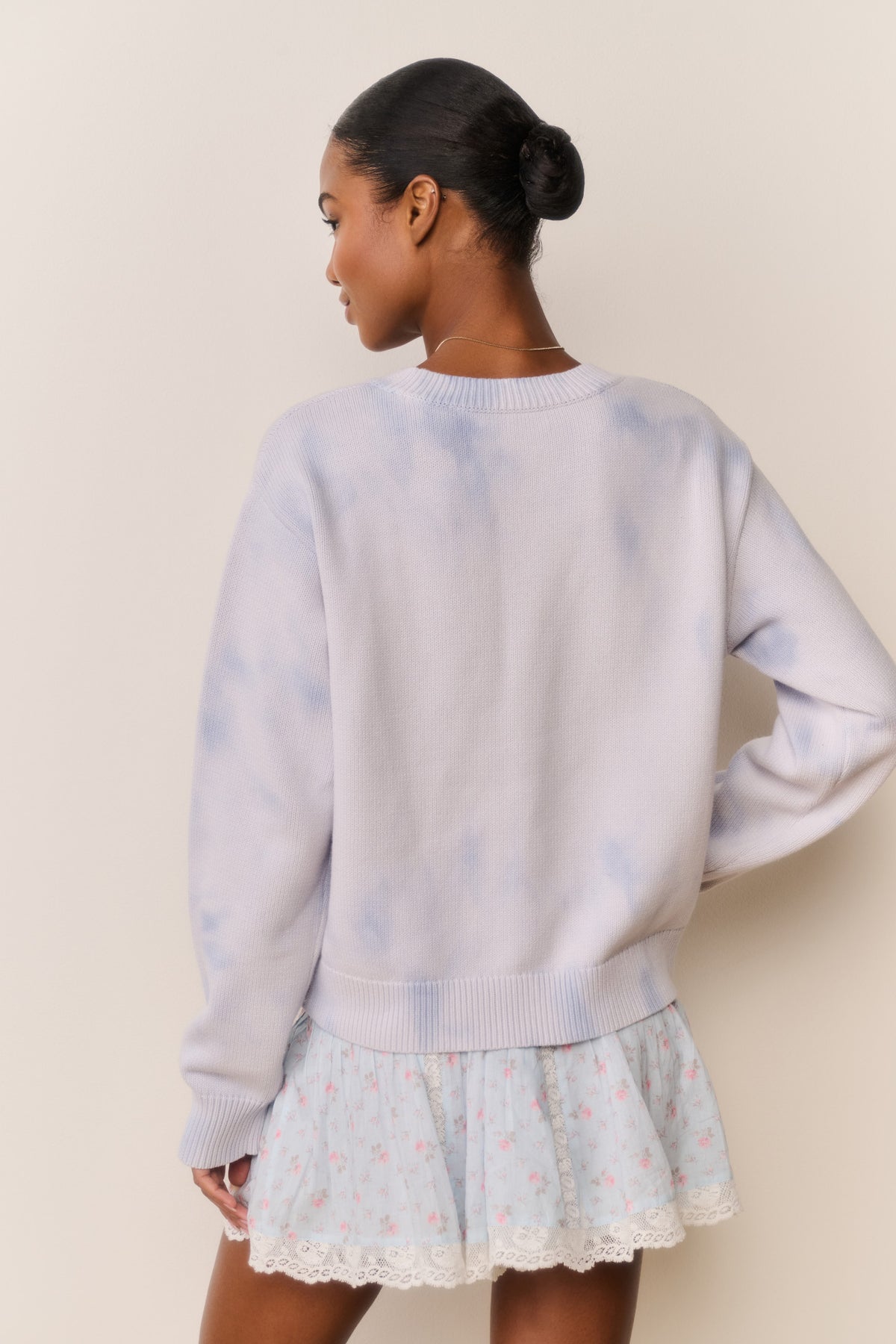 Light blue knit pullover with ribbed hem and cuffs, back view