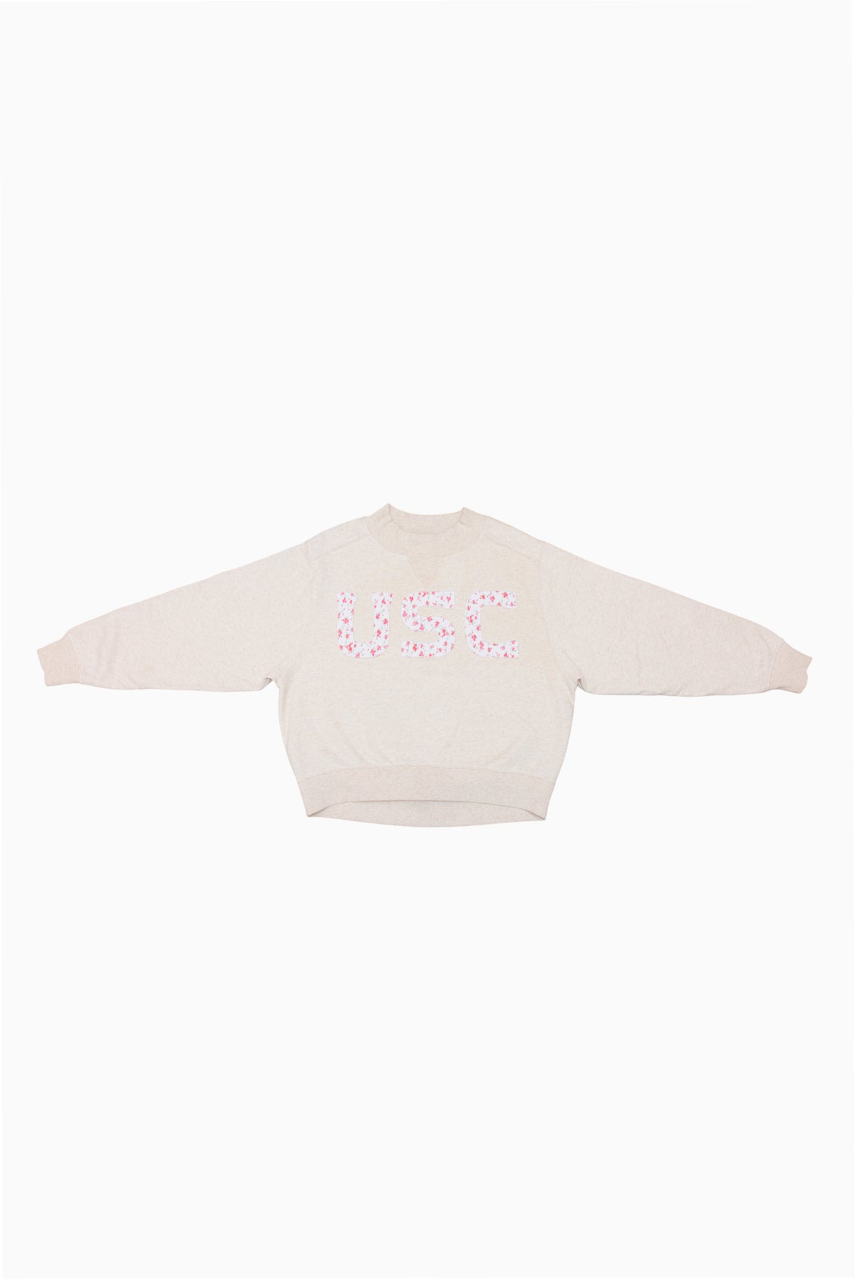 Cream mockneck crew sweatshirt with pink and blue dotted logo at center