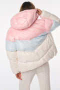 Back view of pink, white and light blue hooded puffer jacket with quilted stripes.