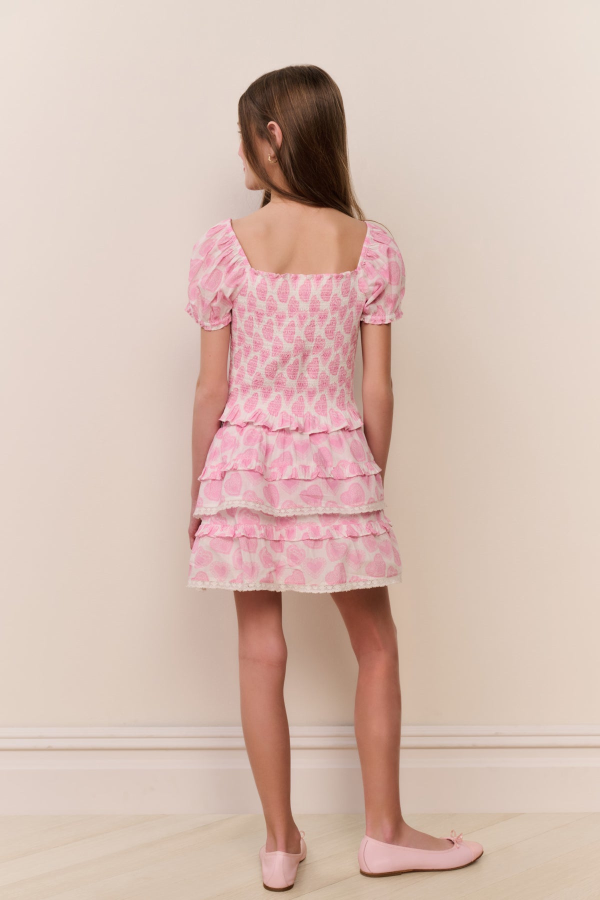 Back view of light pink heart-print tiered ruffle skirt with layered hem