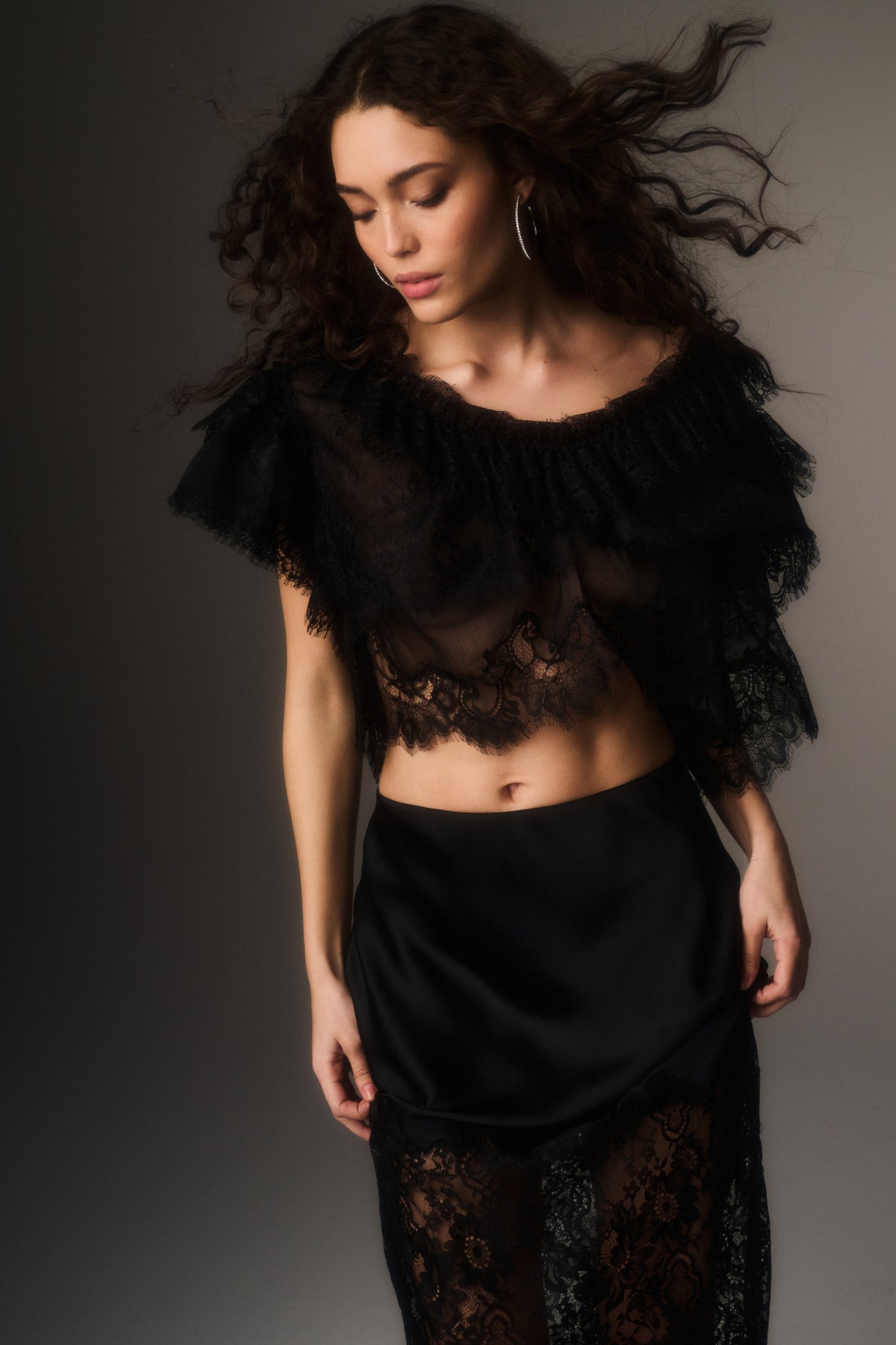 Black lace chiffon cropped top with lace trim and scalloped neckline, close-up