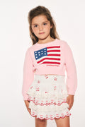 Girls' pink knit flag pullover featuring a red, white, and blue flag patch on front