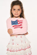 Girls' pink knit flag pullover with red, white, and blue flag patch at chest