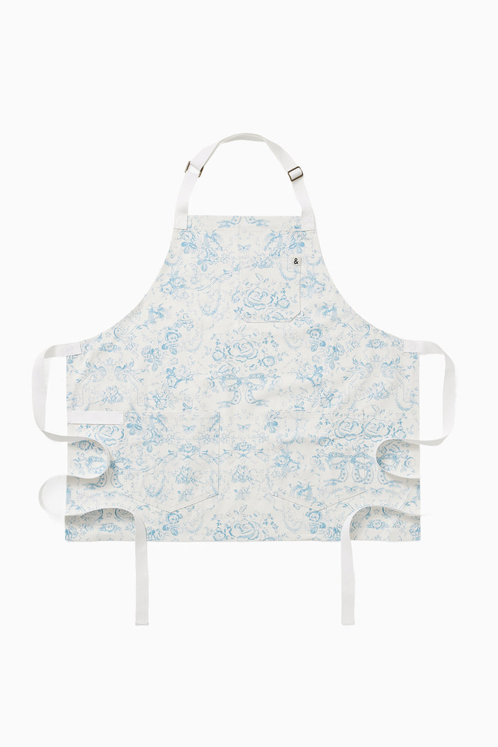 Light blue vintage toile apron with neck strap, waist ties, and front pocket