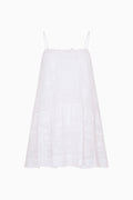 White cotton Victorian mini dress with spaghetti straps and tiered lace texture