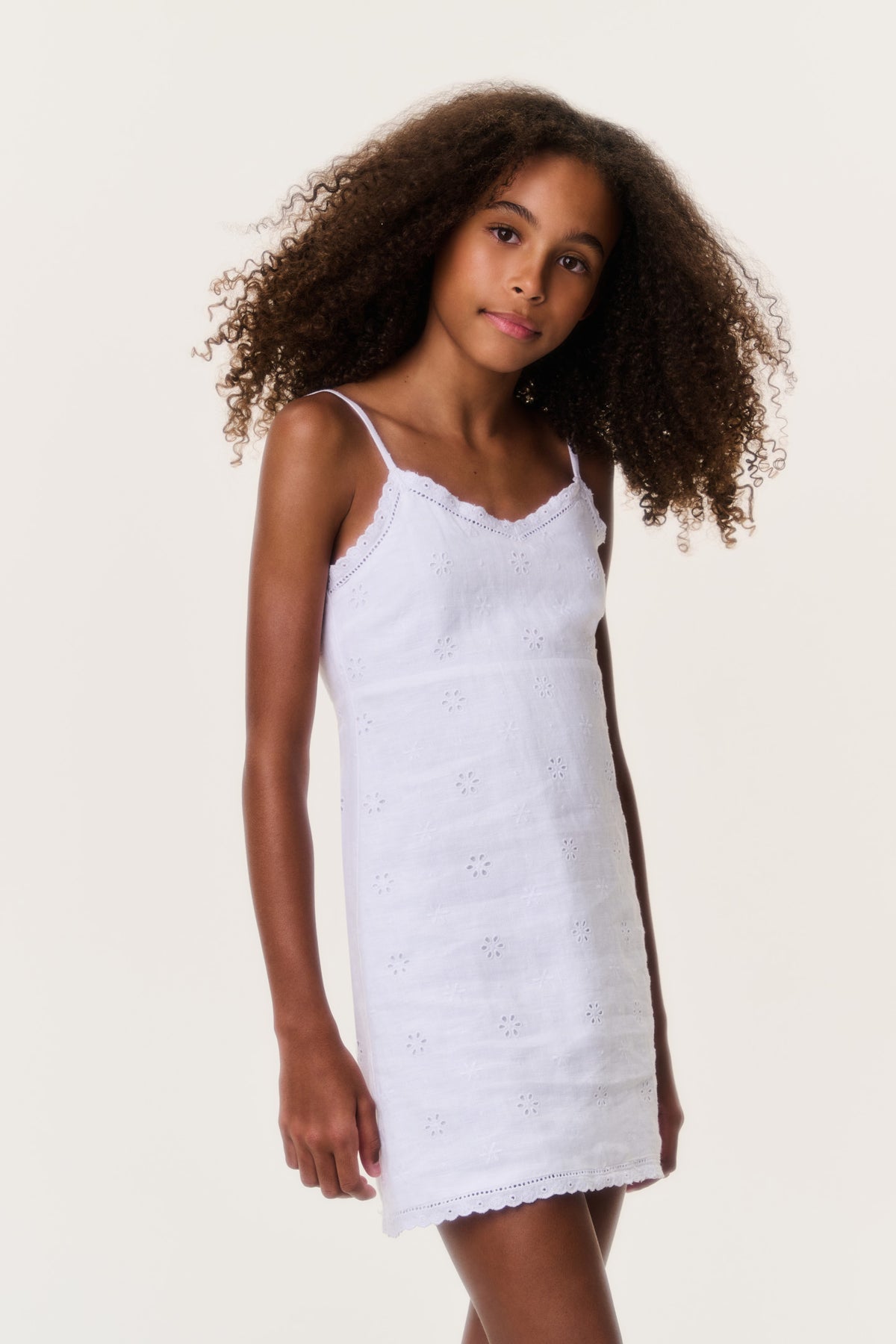 Optic white eyelet linen mini dress with lace-like trim and scalloped hem