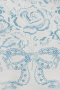 Light blue vintage toile fabric with illustrated figure and floral accents