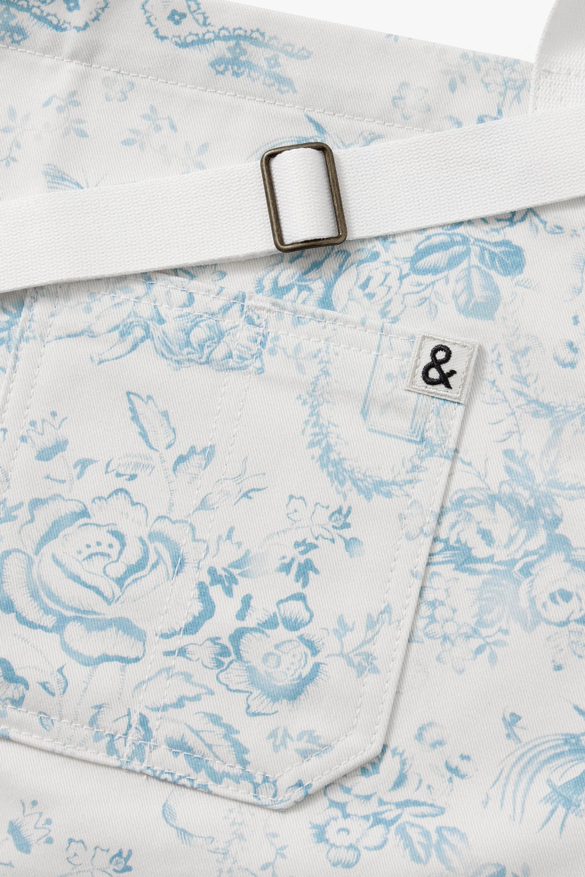 Light blue apron pocket with stitched trim and metal buckle strap