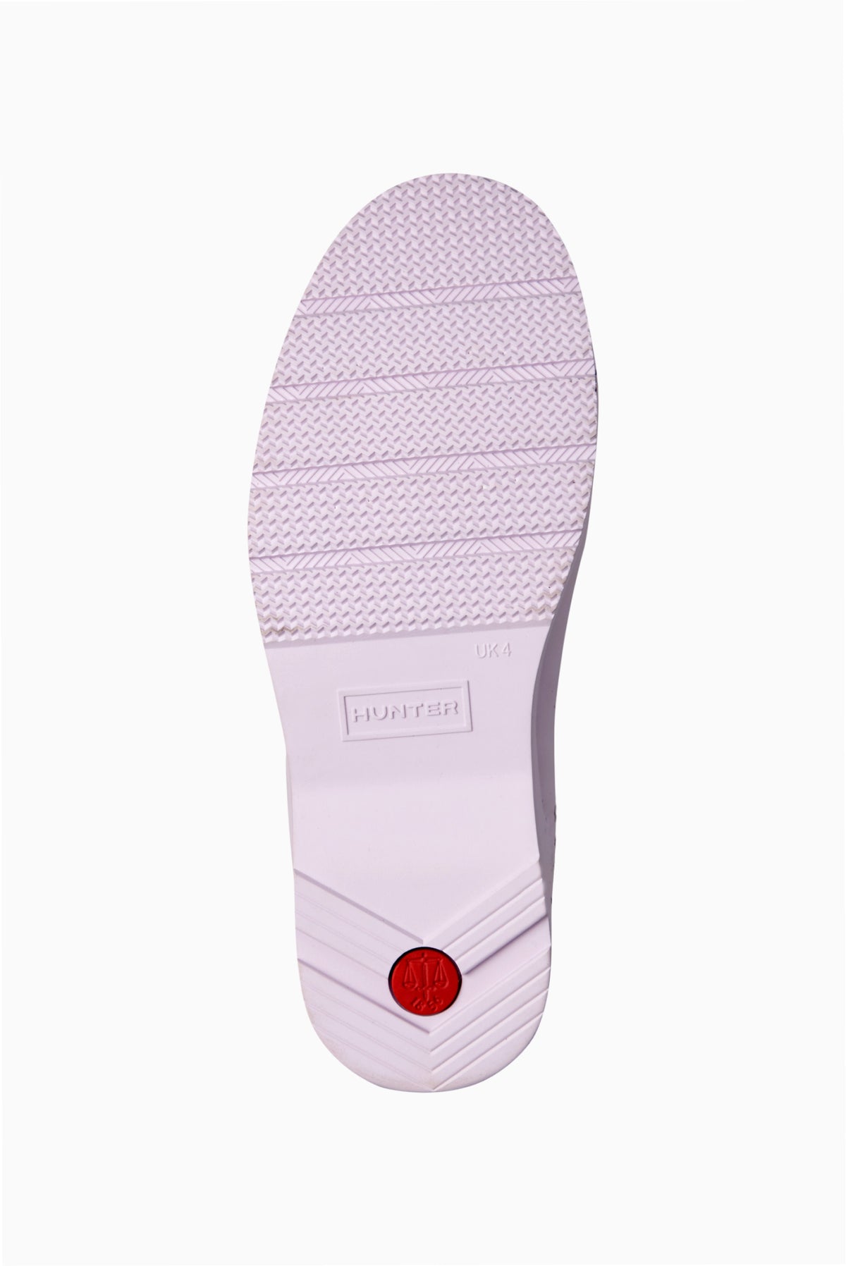 Women’s light purple rain boot outsole with textured tread and red logo button