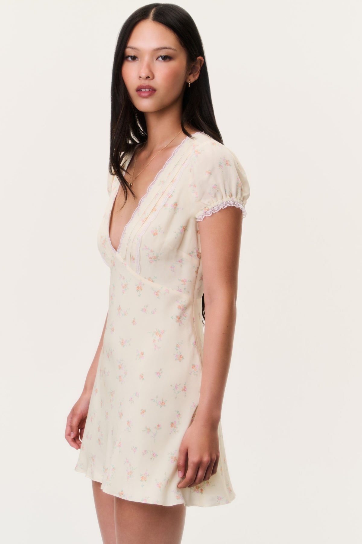 Floral mini dress with lace V-neck and short puff sleeves, light cream, front side view