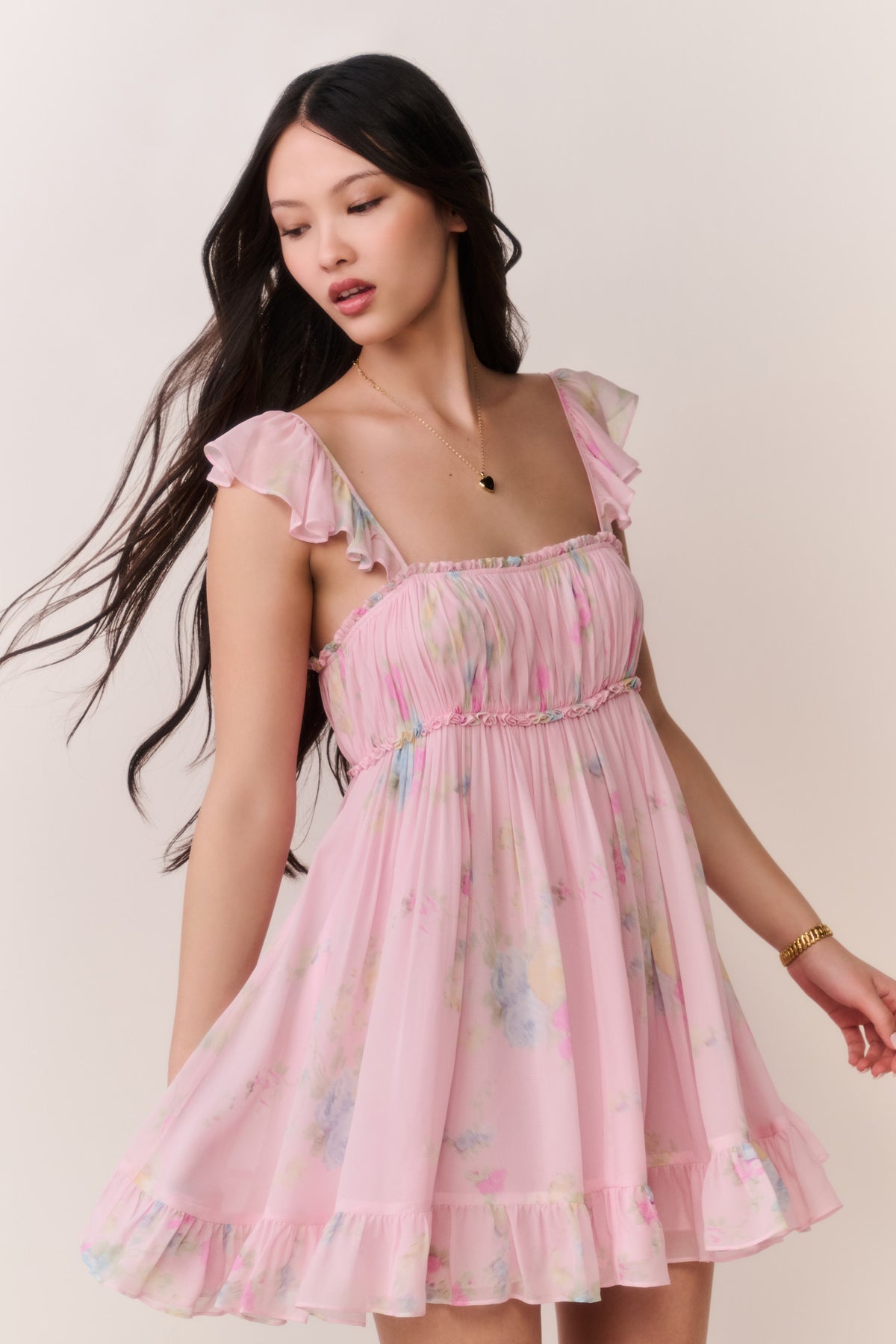 Pink floral chiffon mini dress with ruffled shoulder straps and gathered tiered skirt