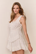 White tiered mini dress with eyelet lace trim and sleeveless fitted bodice