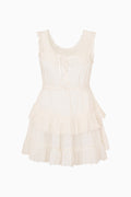 White cotton mini dress with eyelet ruffle trim and button-front bodice