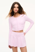Cropped zip jacket in mauve-pink with allover bow print, long sleeves, fitted waist