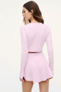 Back view of cropped zip jacket with allover bow print, long sleeves