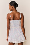 Back view floral cotton mini dress with adjustable spaghetti straps and lace trim