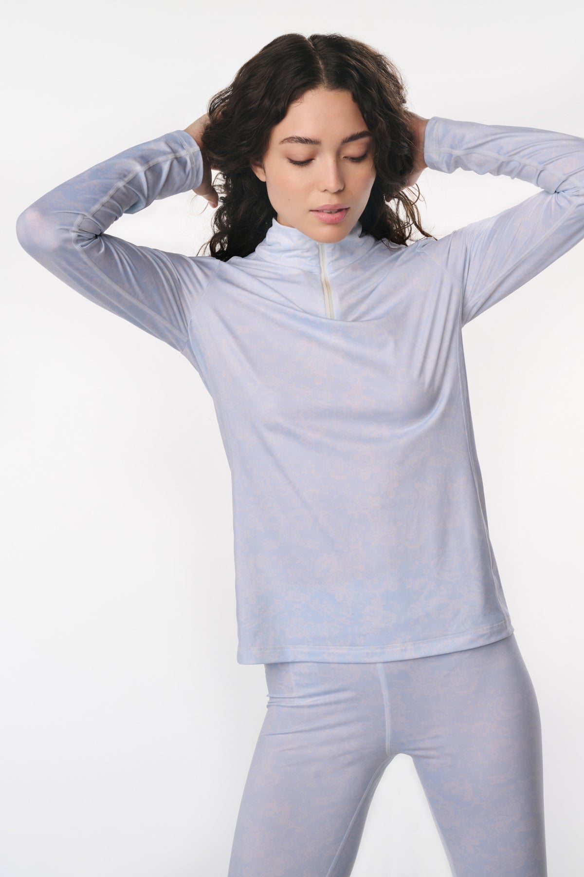 Light blue long-sleeve pullover top with crew neck and thumbhole cuffs