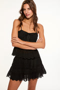Black lace mini skirt with layered tiers and bow-tie detail at waist
