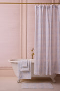 Cotton hand towel in light blue, folded and placed in a small basket