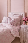 Ruffle heart pillow with light pink floral print and gathered ruffle borders