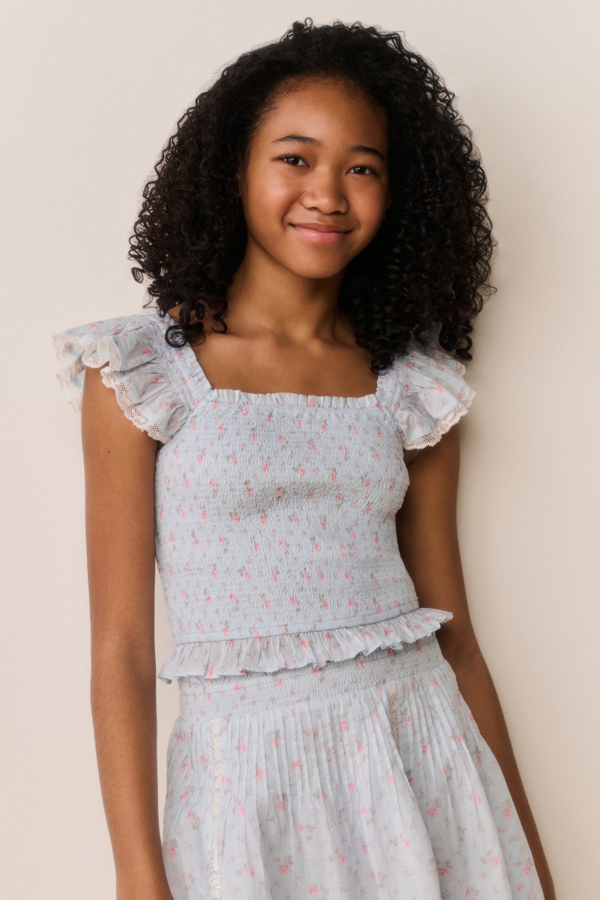 Floral cotton top with square neckline, ruffled sleeve edges, and textured waist gathers