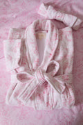 Close-up of light pink floral cotton bath robe belt tie and hooded neckline, long sleeves