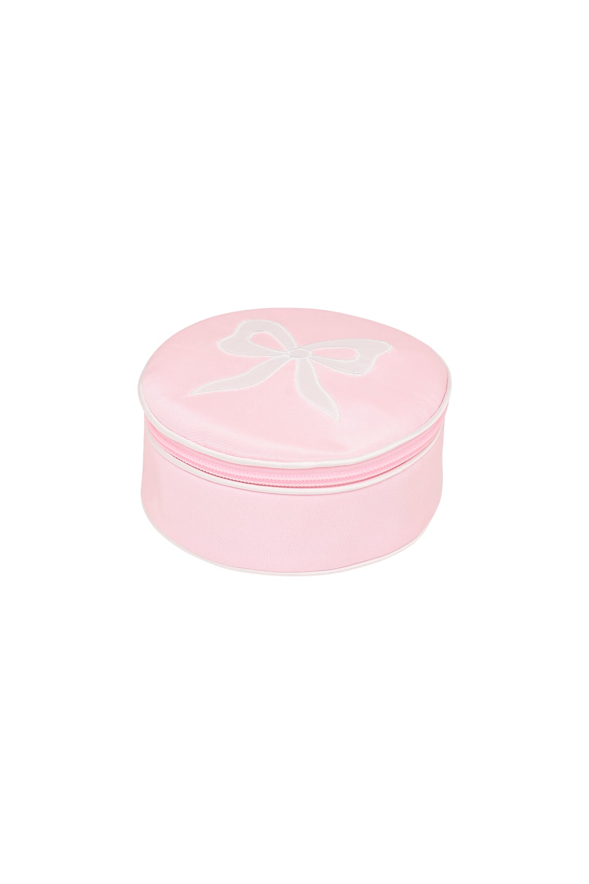 Round zip jewelry case in dusty rose pink, top view with bow outline on lid
