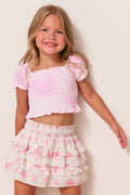 Girls cotton top in peony pink with puff sleeves and smocked front.