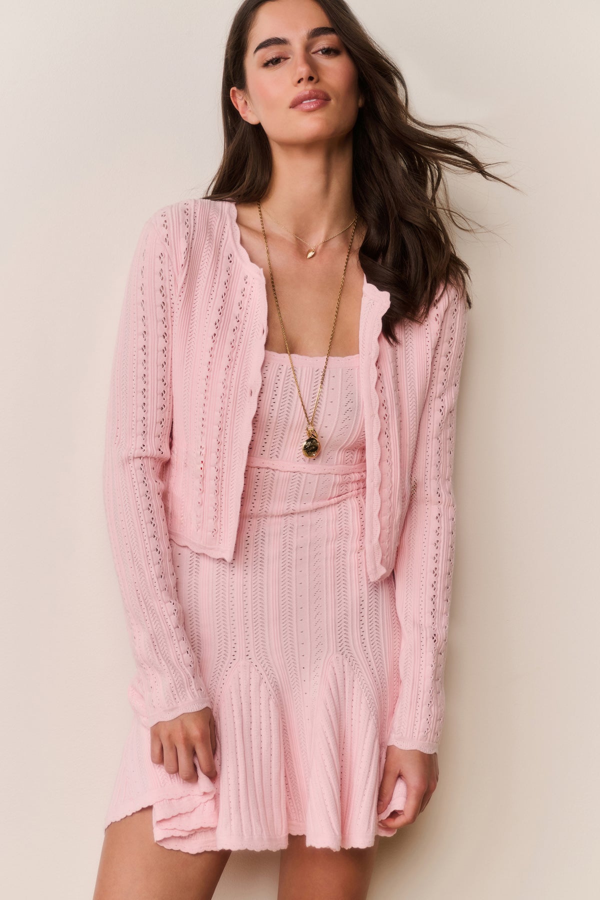 Pink pointelle stretch cardigan with open front and long sleeves, knit texture