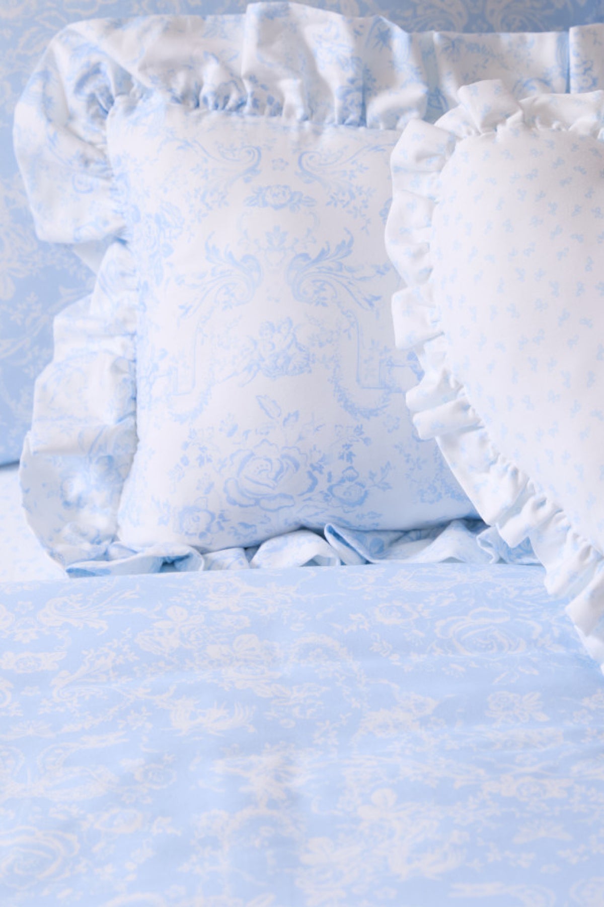 Light blue floral duvet cover and sham set close-up with ruffled edges