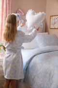 Light blue floral cotton bathrobe with tie belt and shawl collar, shown from side