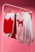 Cotton cami tanks on a rack, including red and light heather styles