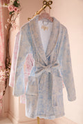 Blue floral cotton bathrobe with shawl collar and tie belt, long sleeves, robe hanging