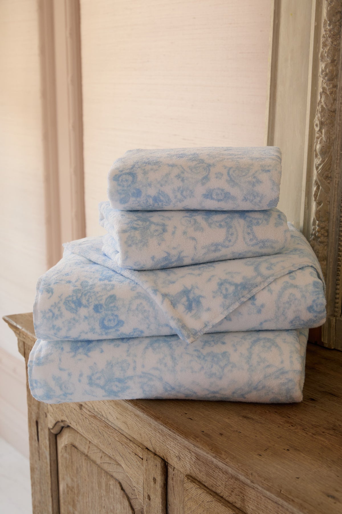 Cotton bath towel set, light blue floral bow print, folded stack with plush terry.
