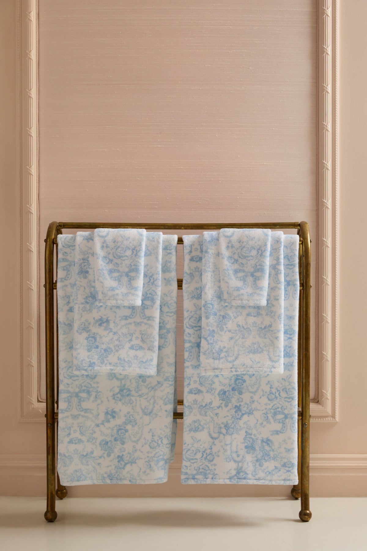 Cotton bath towel set, light blue floral bow pattern, neatly folded pair.