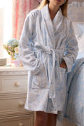 Light blue floral cotton bathrobe with shawl collar and belt tie, long sleeves, front view