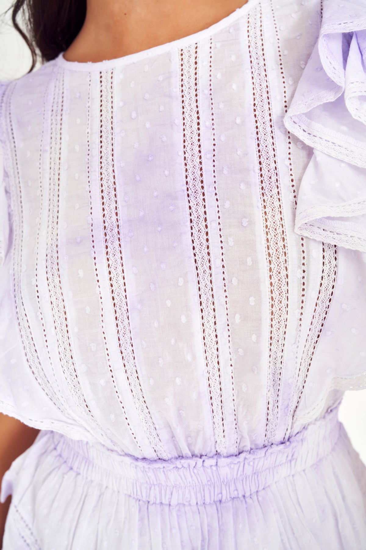 Lavender mini dress bodice close-up with vertical embroidered stripes and ruffle shoulder detail