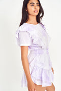 Lavender mini dress with ruffled sleeves, smocked waist, and tiered ruffle skirt